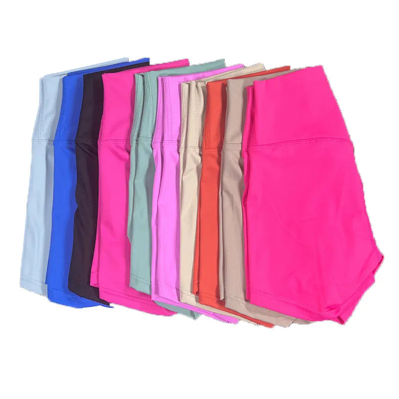 Ladies high-waisted nylon yoga shorts in various colours on a rack