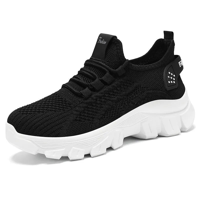 Women's white Flyknit running sneakers with a thick PVC sole and lace-up front.