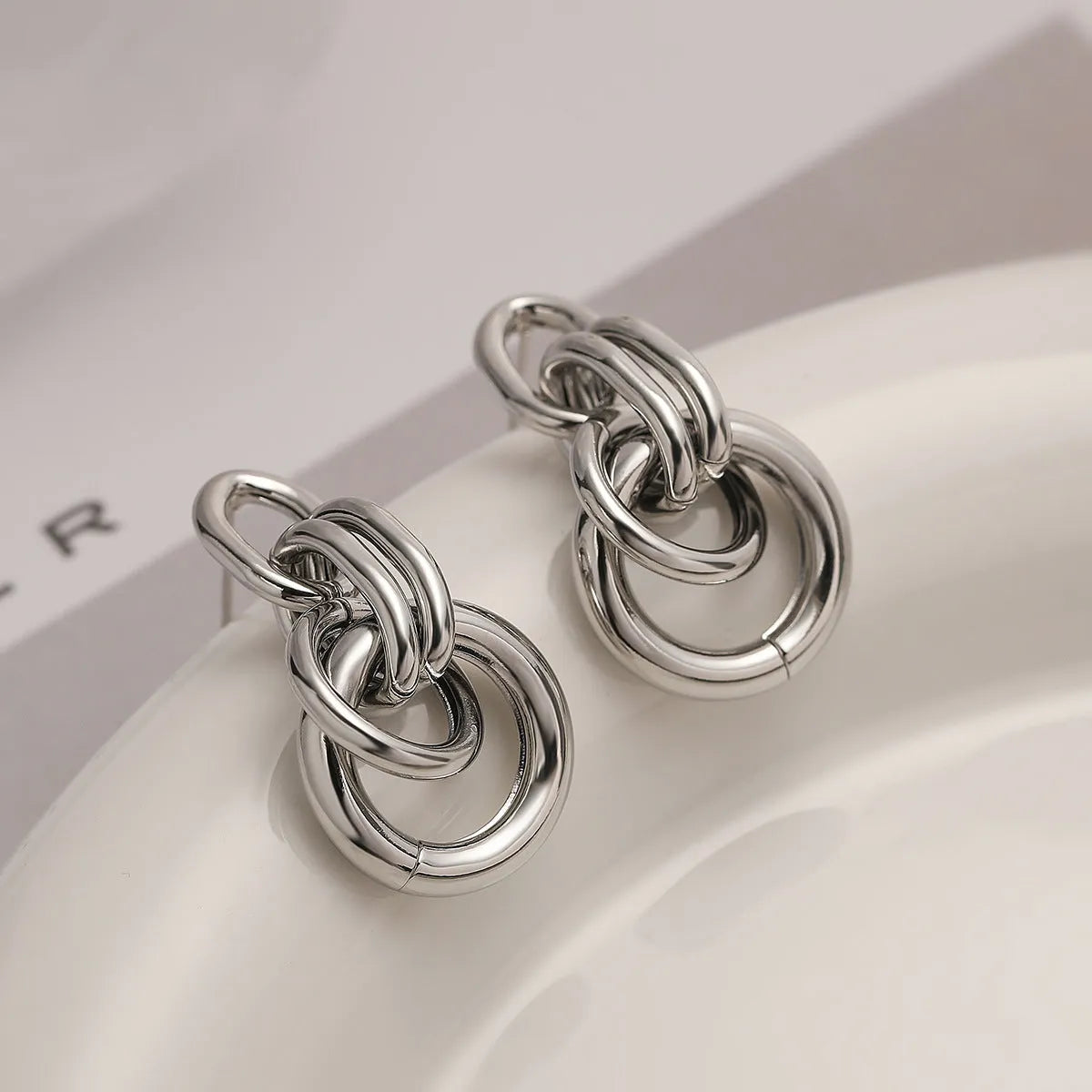 Gold-colour geometric earrings with irregular shapes and INS high-profile design