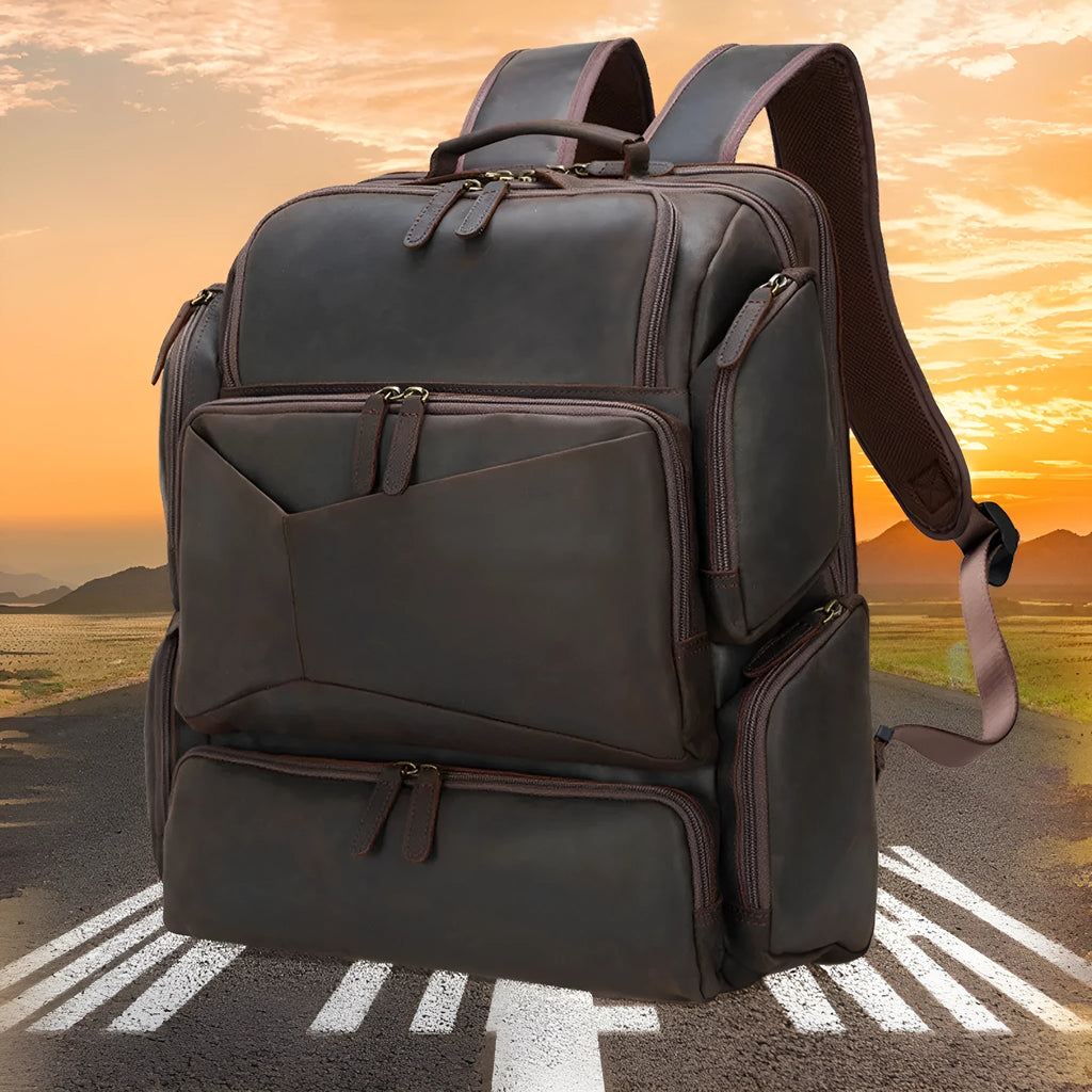 Dark brown genuine leather men's backpack showing 17-inch computer compartment and multiple interior pockets