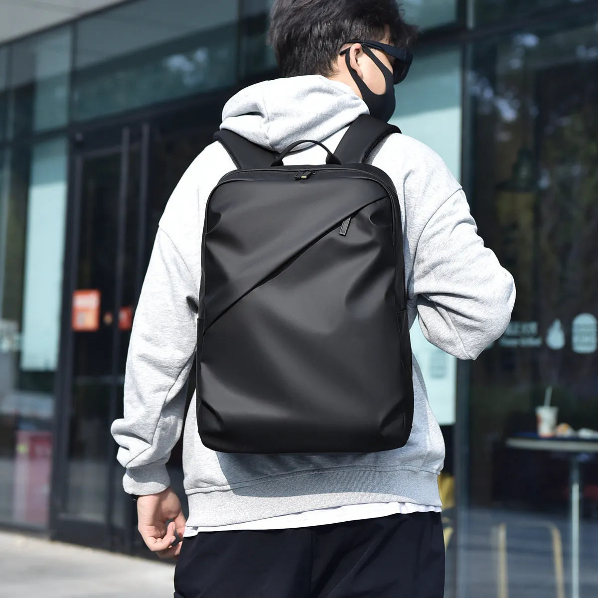 Large waterproof backpack in PU leather with sewing thread detailing and computer bag