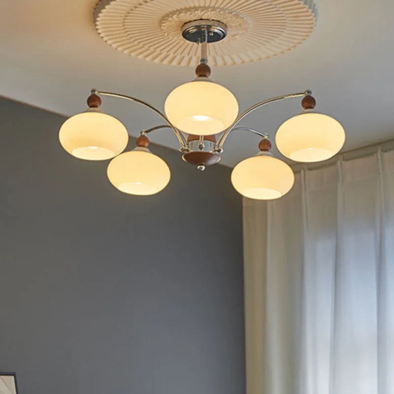 Chrome and persimmon glass chandelier ceiling light with multiple bulbs for dining room.