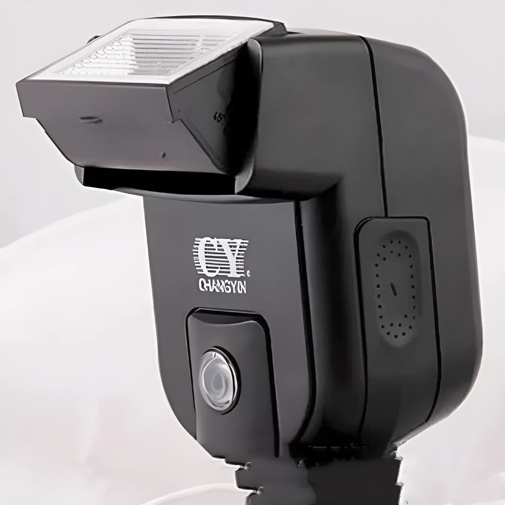 Compact silver SLR camera flash with a rotating head on a hot shoe mount