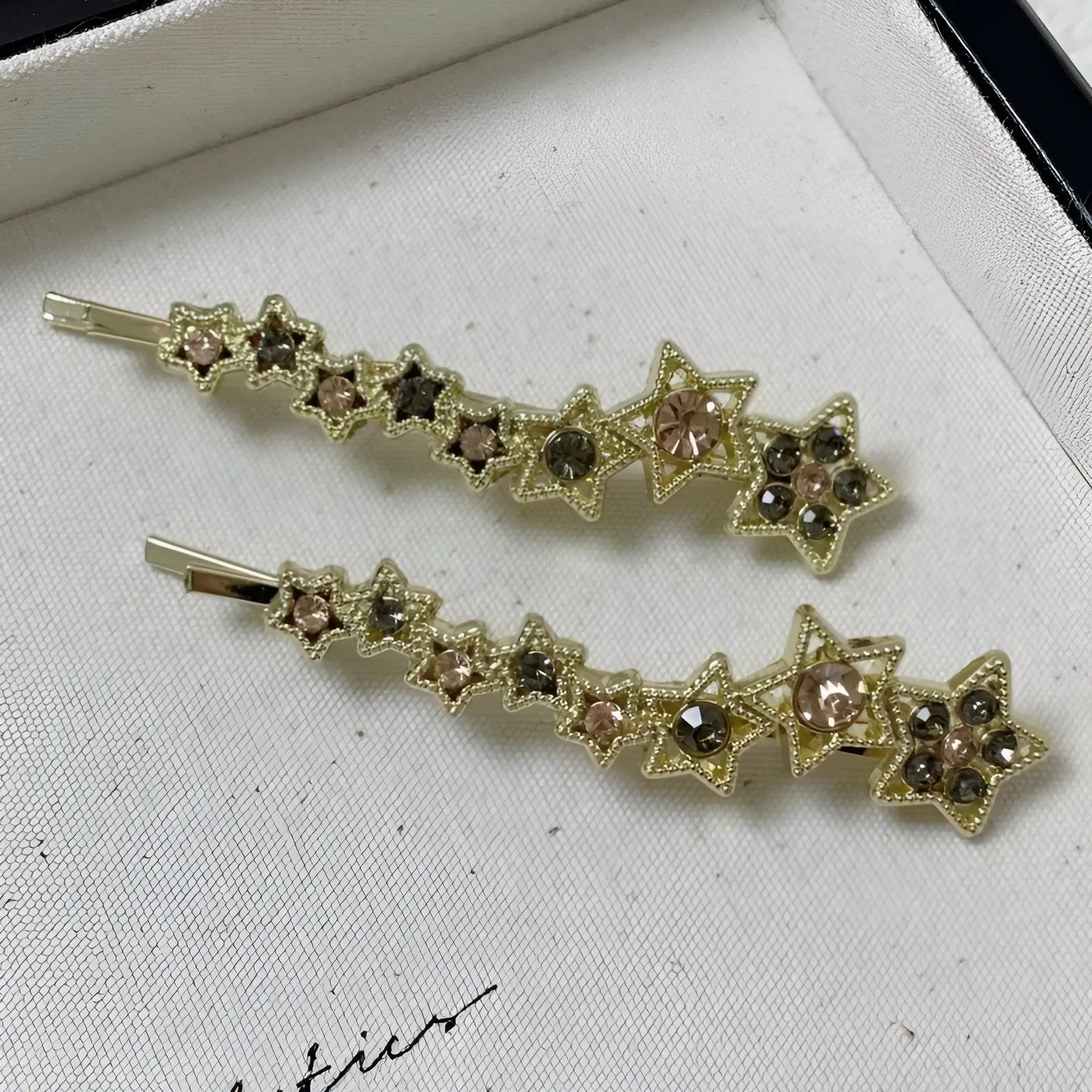 Gold electroplated rhinestone barrette with star design and side clip for bangs
