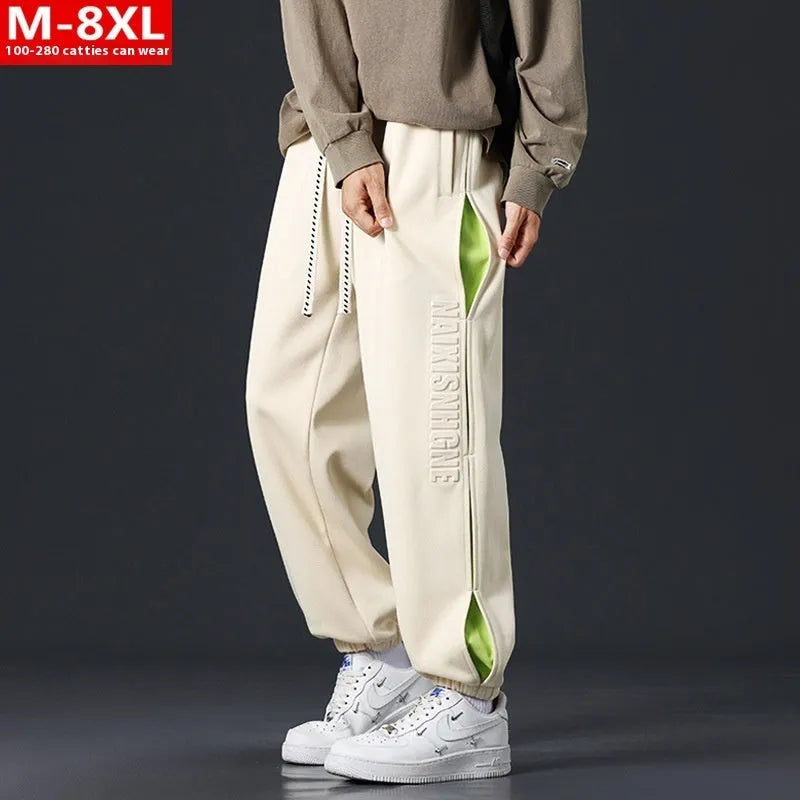 Men's loose-fit ankle banded cotton trousers with stitching detailing and skinny leg opening in grey green colour