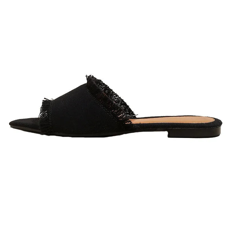 Women's denim flat slippers with tassel detail and leather lining in apricot colour.