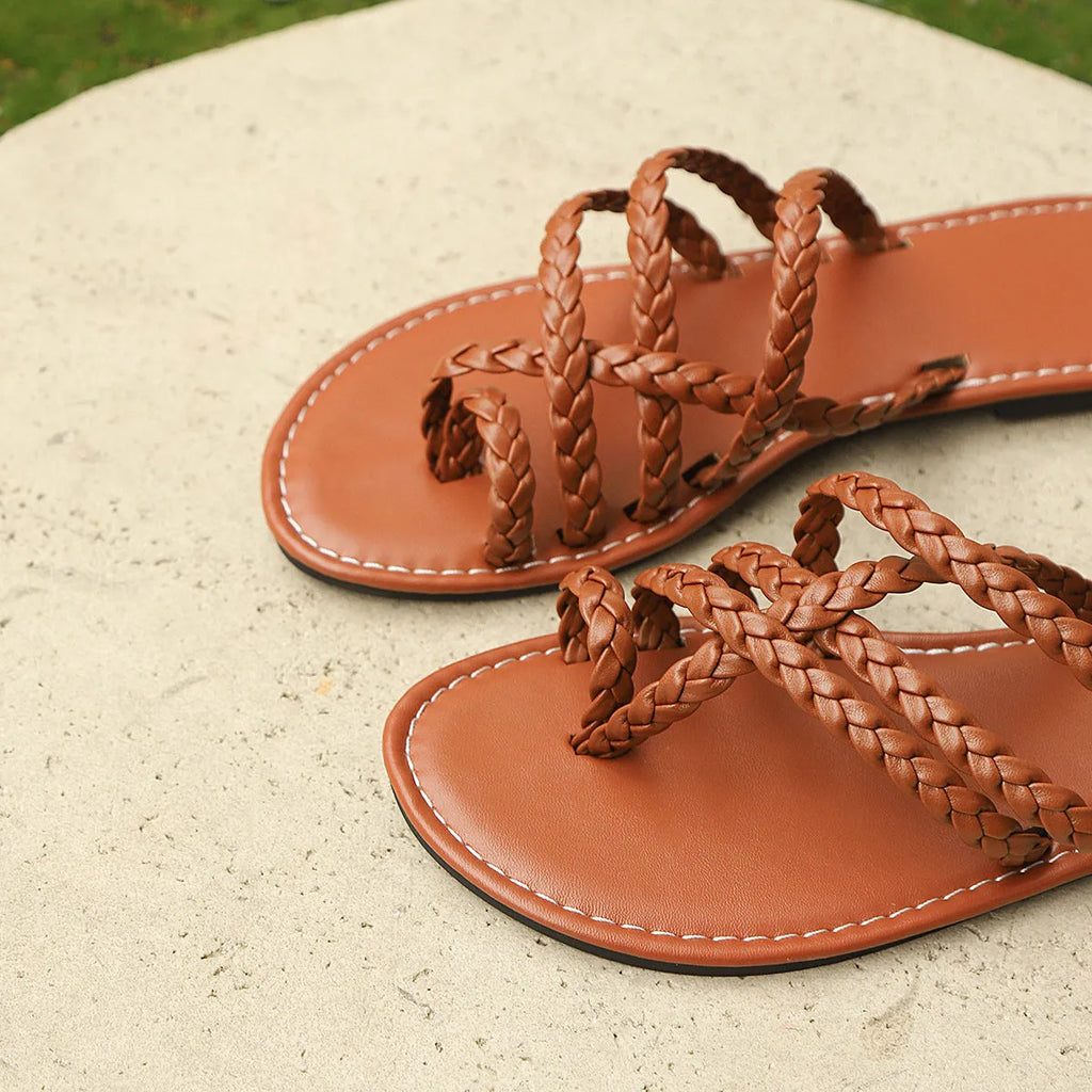 Women's black clip-toe woven flat slide sandals on a white background.