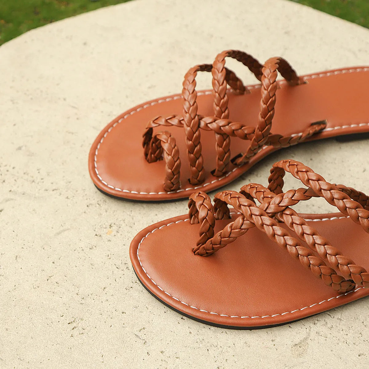 Women's black clip-toe woven flat slide sandals on a white background.