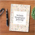 A5 weekly pregnancy diary notebook open to weekly tracking pages