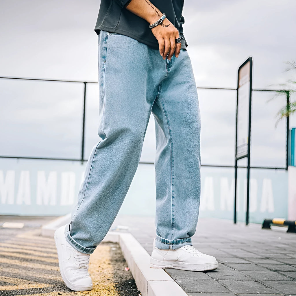 Men's loose straight-leg casual jeans in dark blue cotton fabric with a zip fly.