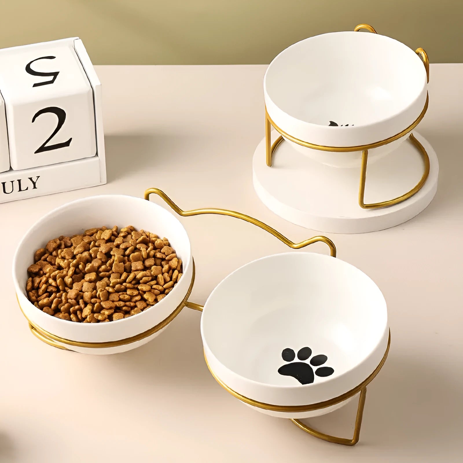 White ceramic cat bowl with cat paw design in black iron frame with cat ears