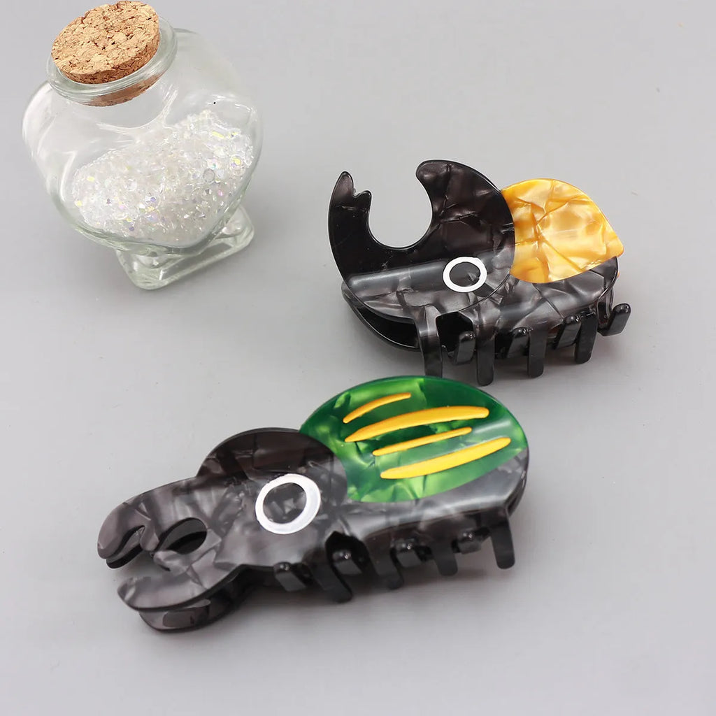 Handmade cellulose acetate Beetle Grip insect biology teaching tool with cartoon caterpillar design