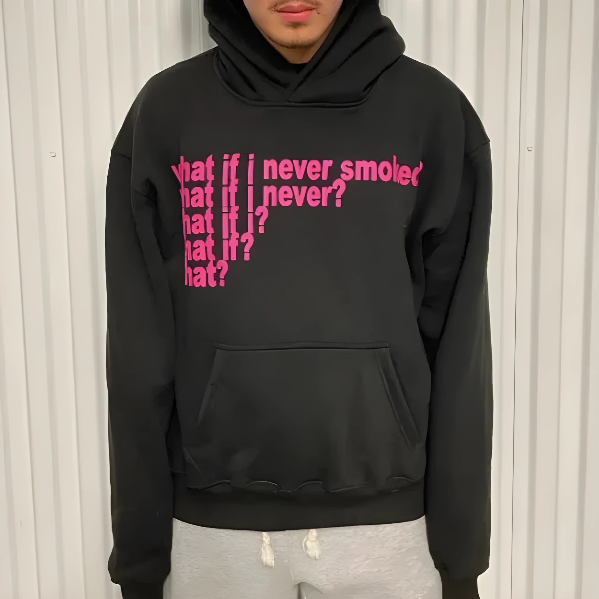 Black hooded sweater with white letter print design, showing front view with hood up