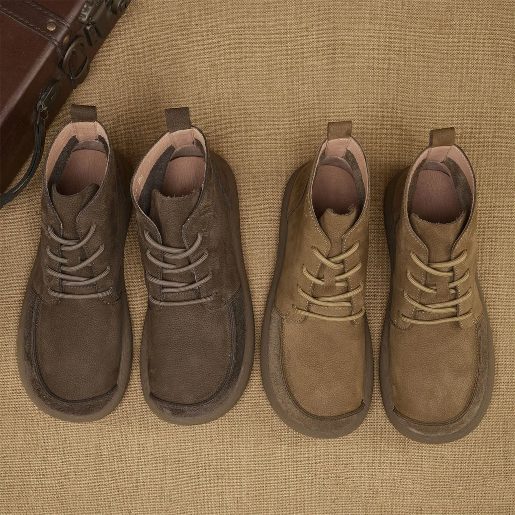 Grey genuine leather Martin boots with lace-up front and wedge heel on a plain background.