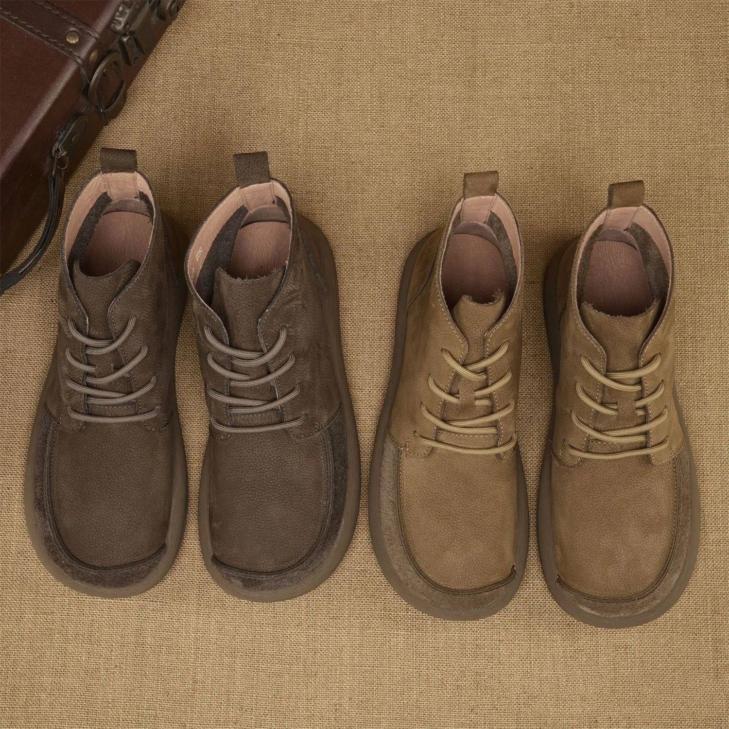 Grey genuine leather Martin boots with lace-up front and wedge heel on a plain background.