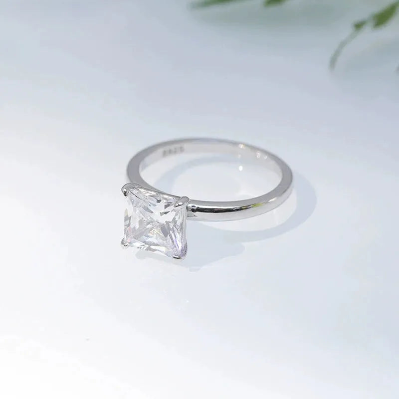 925 sterling silver geometric ring with round detail in silver, gold, and rose gold colours on a white background.