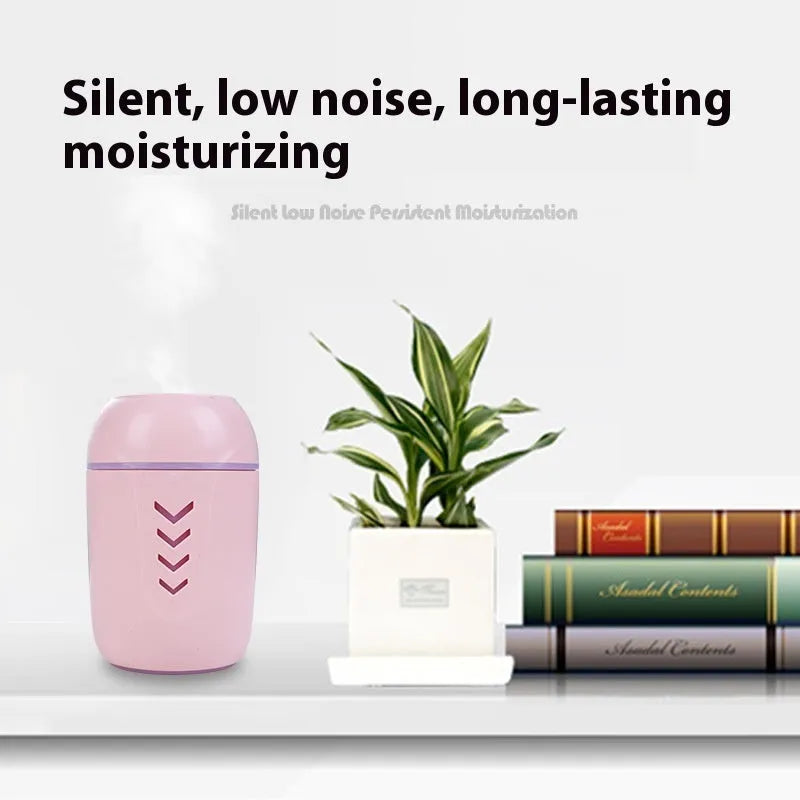 Round white portable USB air purifier on a wooden desk next to a laptop.