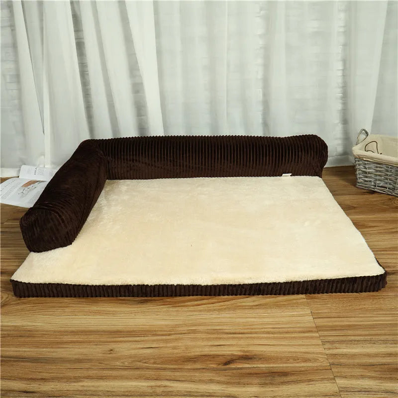 Corduroy pet sofa dog bed with bolster, shown in a grey colour on a wooden floor.