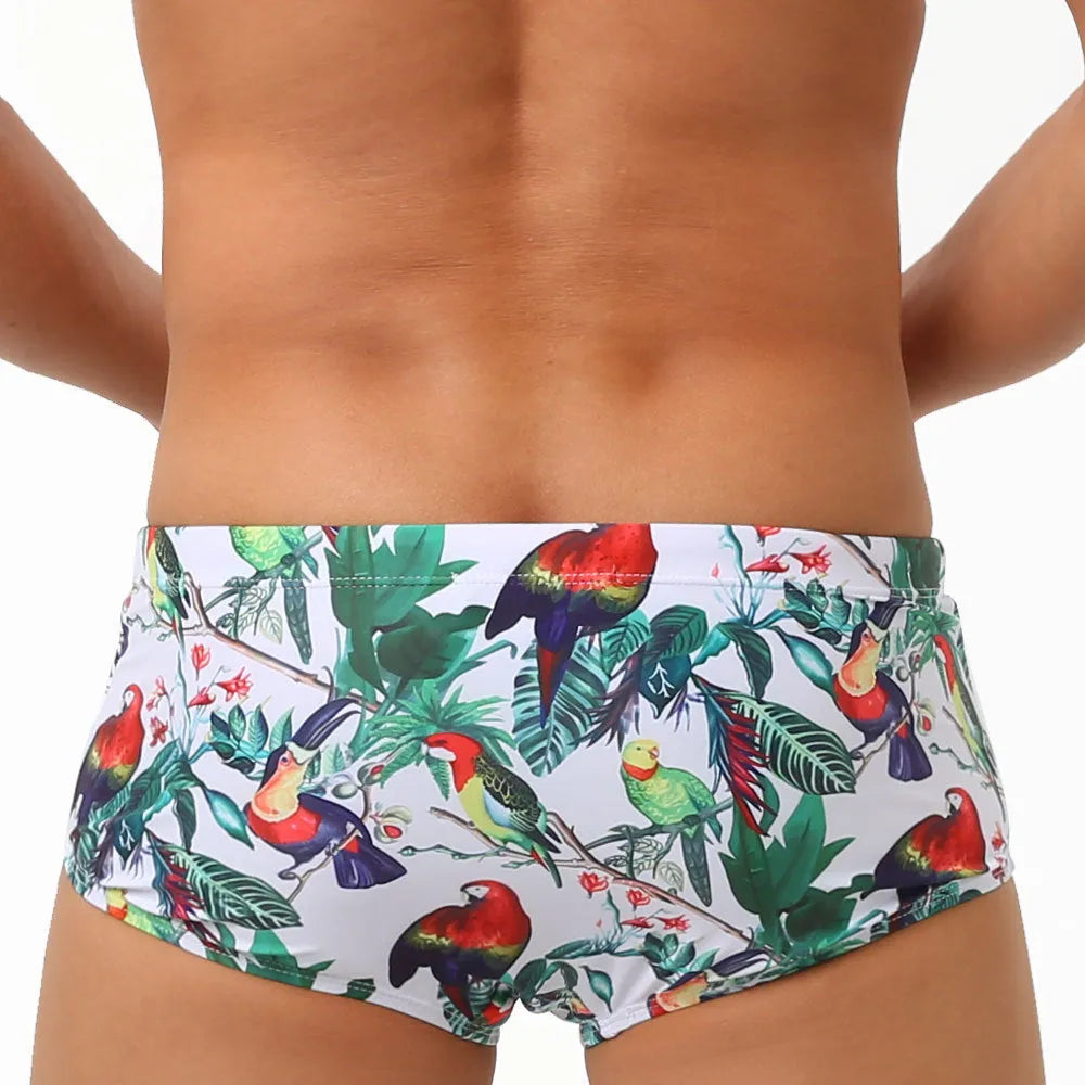 Men's navy swim trunks with colourful flower and bird print pattern, boxer style