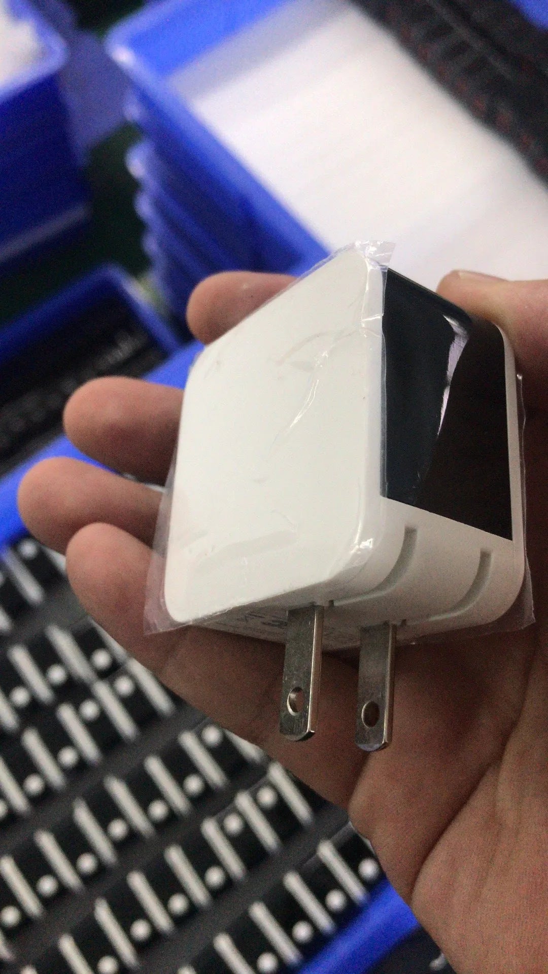 Black 5V2A dual USB travel charger with digital display showing charging status next to a smartphone.
