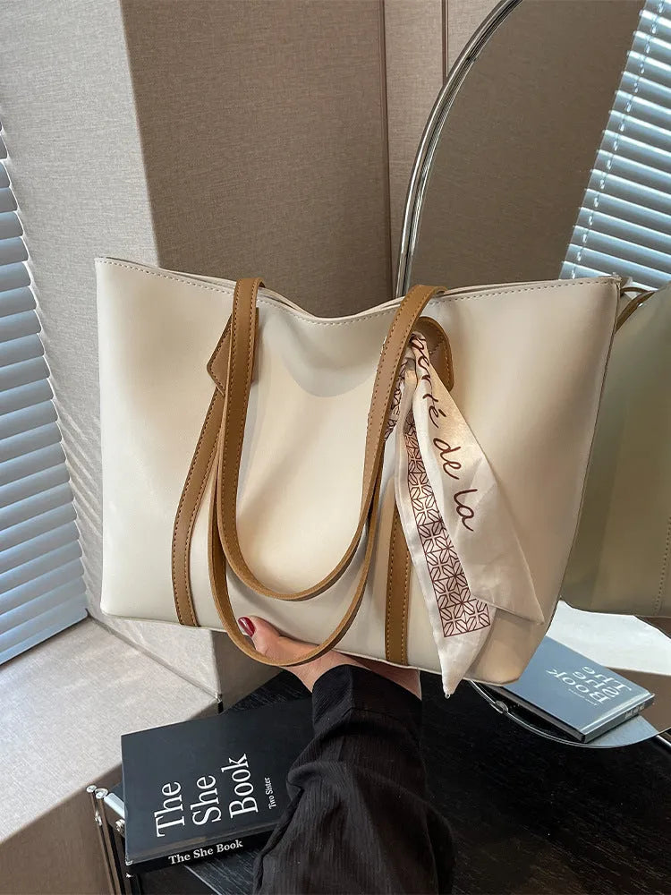 Women's soft large capacity tote bucket shoulder bag in khaki colour showing crossbody strap and front sandwich pocket.