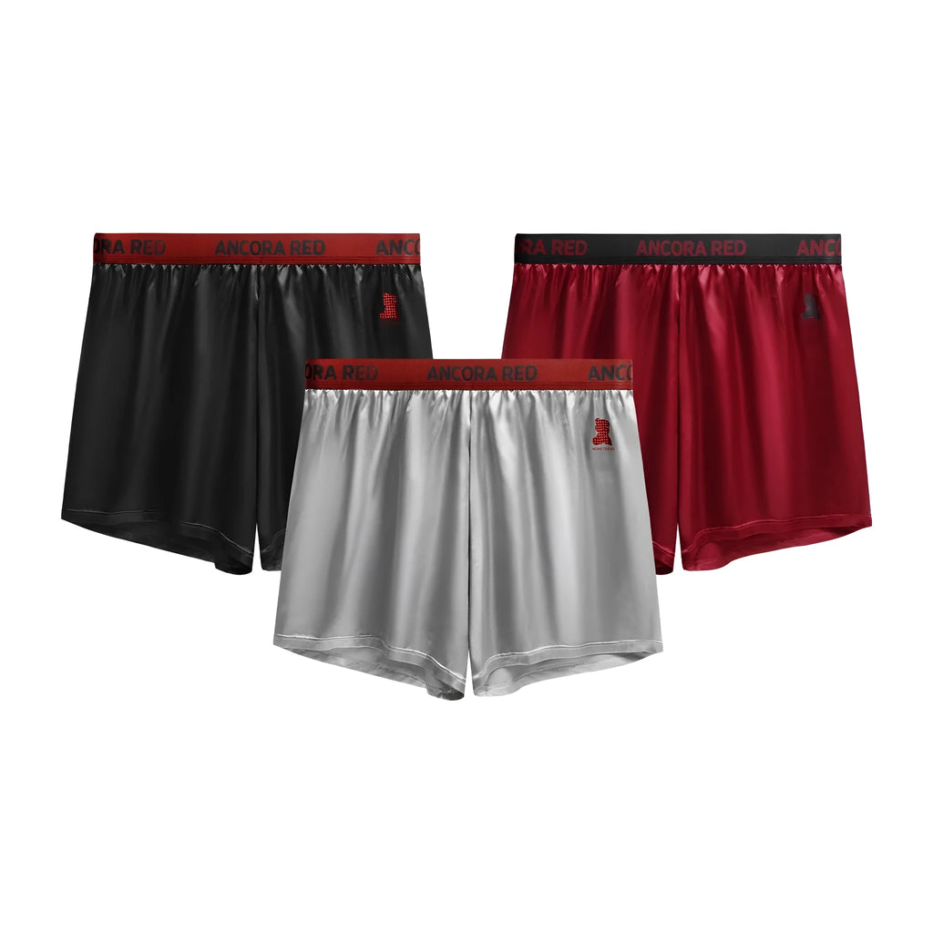 Men's solid colour polyester boxer briefs in black, shown laid flat to display the mid waist design.