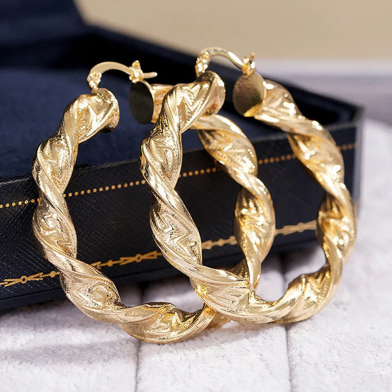 Geometric ring design drop-shaped ear clip earrings for women in a metallic electroplated finish.