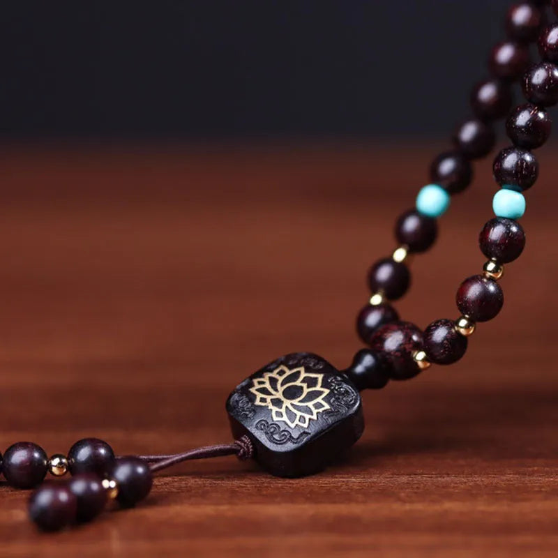 Zambia rosewood bead bracelet with flat lotus pendant showing 108 wooden beads