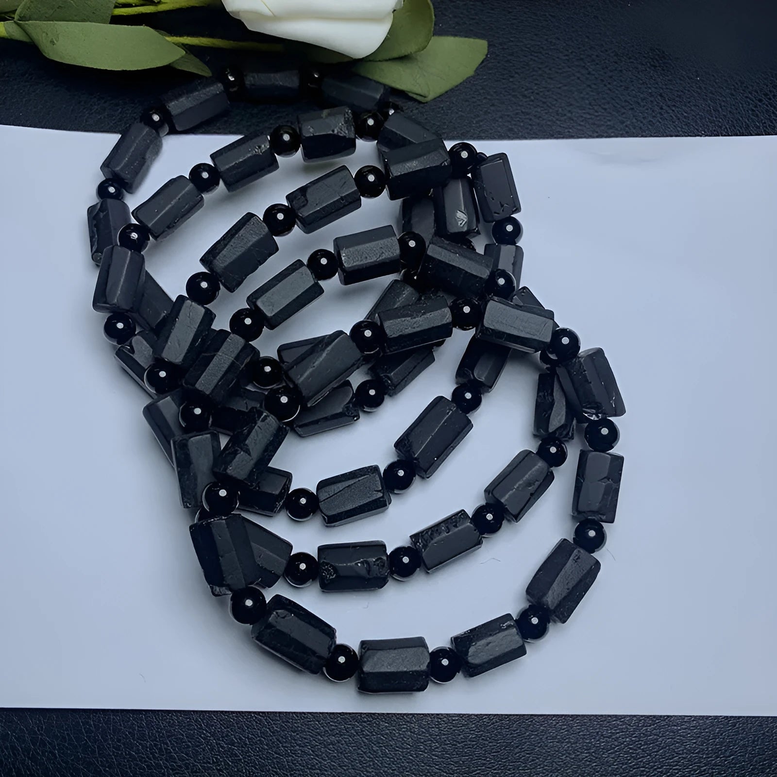 Natural black tourmaline rough stone bracelet showing authentic crystal texture on approximately 9mm beads