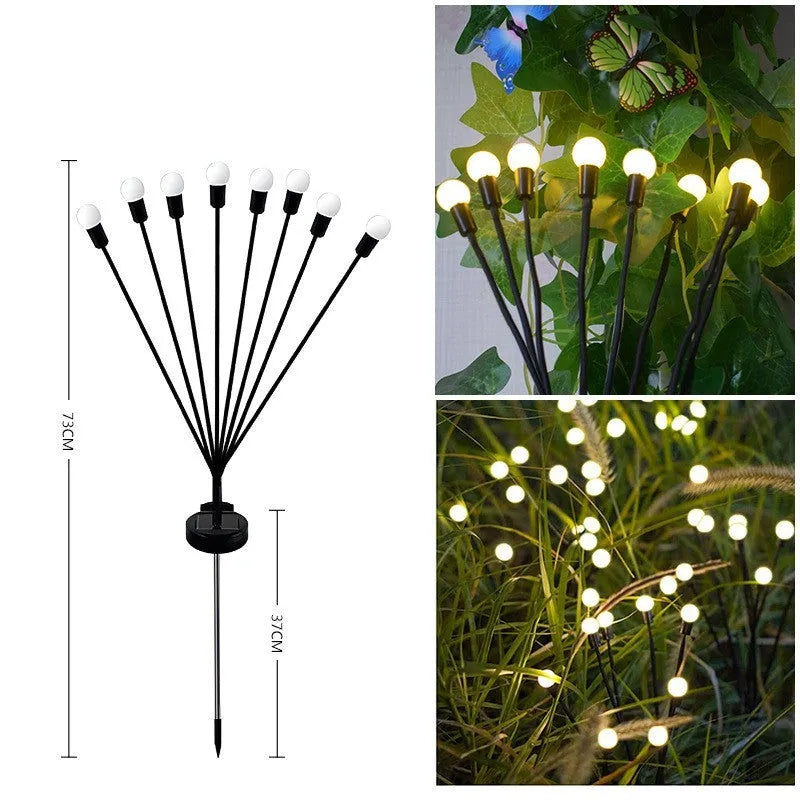 Solar-powered LED ground lamp with multiple heads inserted in garden soil alongside pathway