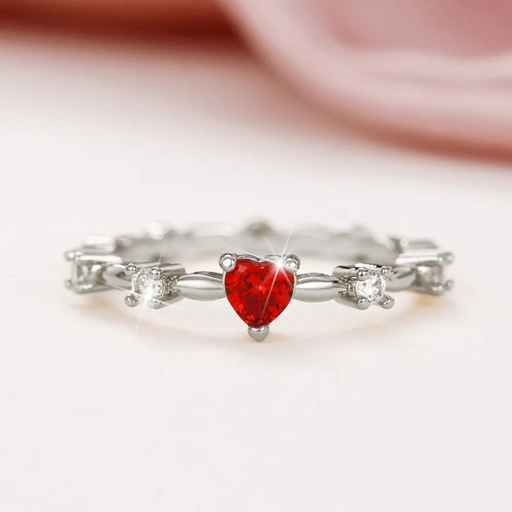 Gold or silver electroplated peach heart fashion ring with zircon stone accents on a copper band.