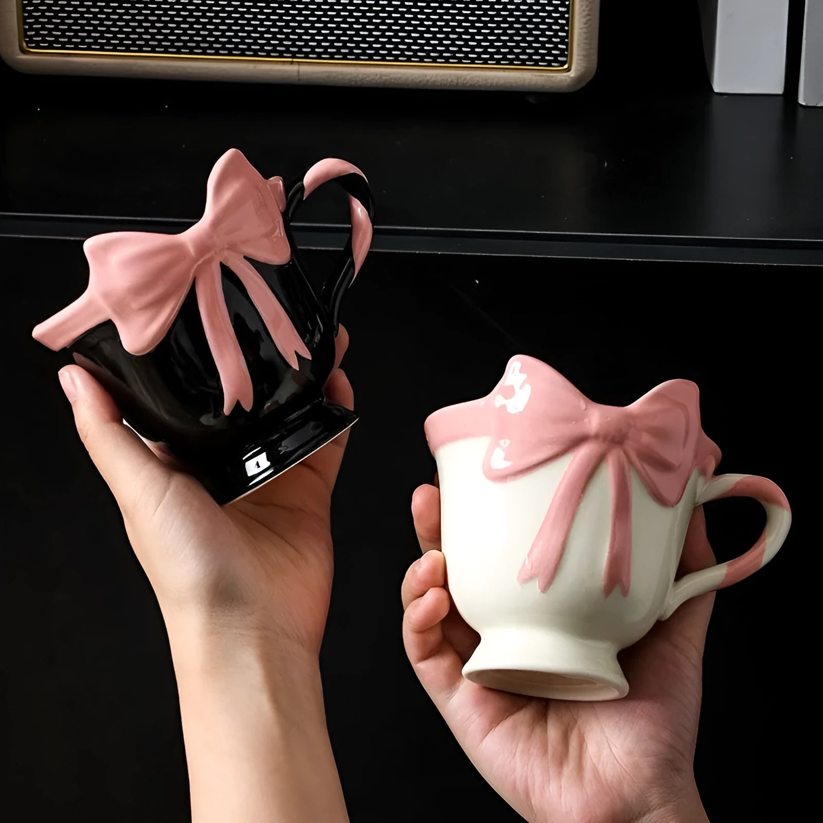 Ceramic mug with heart and bow design in white or black pink colours