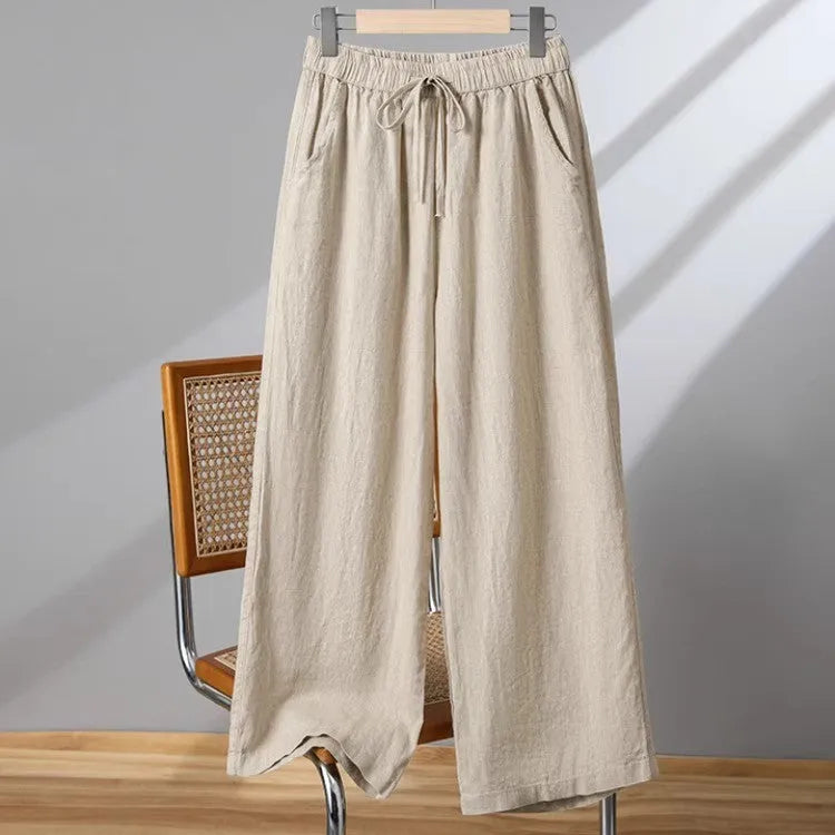 Women's straight-leg casual trousers in apricot colour with an elastic and drawstring waistband.