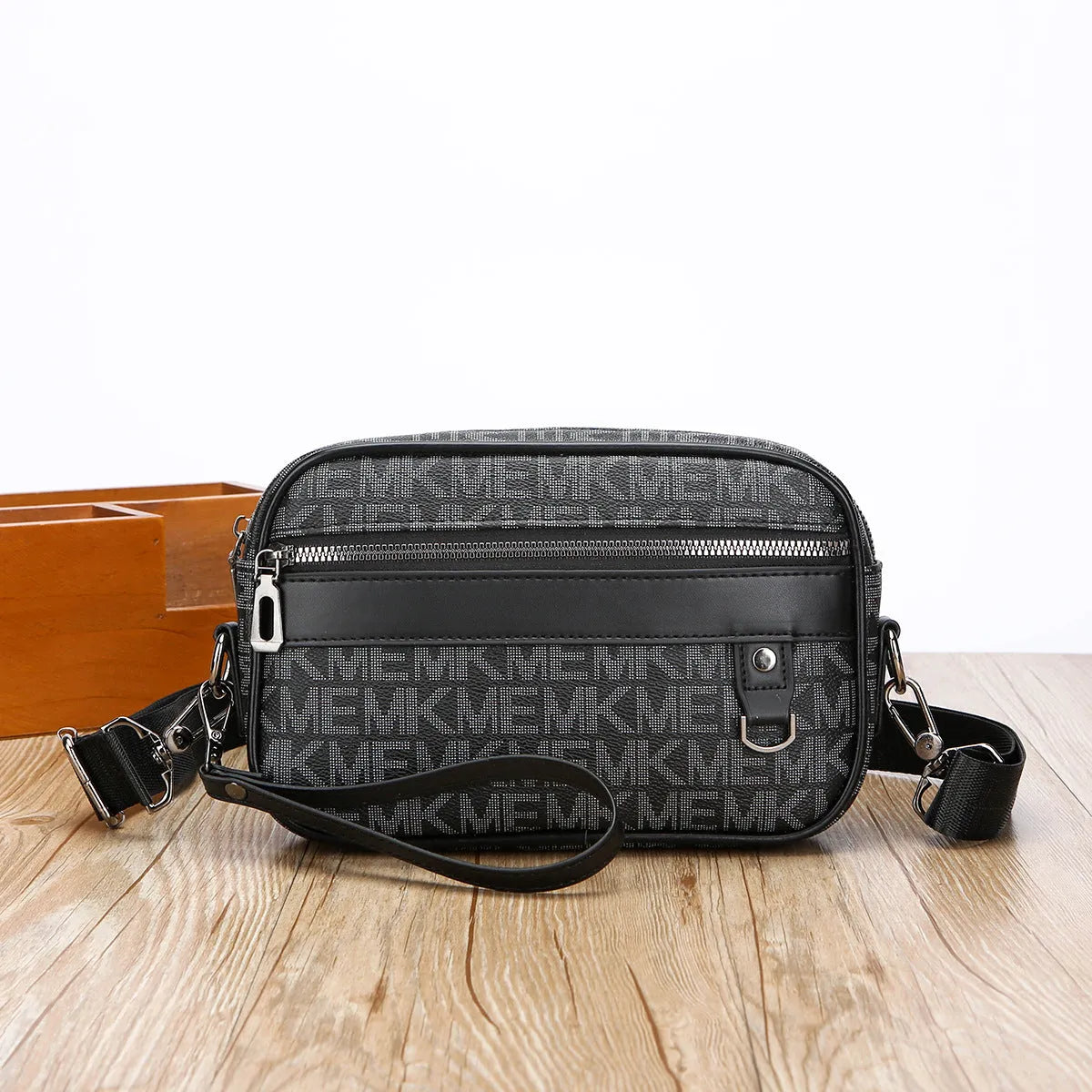 Men's black geometric pattern messenger bag showing shoulder strap and handheld carrying options