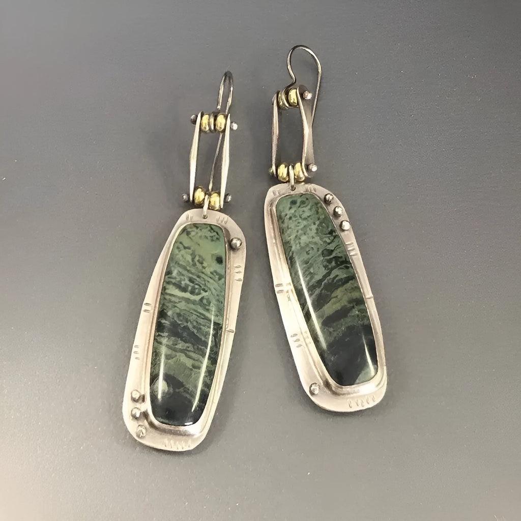 A pair of geometric-shaped alloy earrings with a black and white marble pattern print.