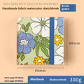 Feiluniao fabric watercolour sketchbook open showing a detailed hand-painted design on paper.