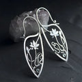 A pair of silver women's earrings with a lotus vine and geometric design featuring round rhinestones.
