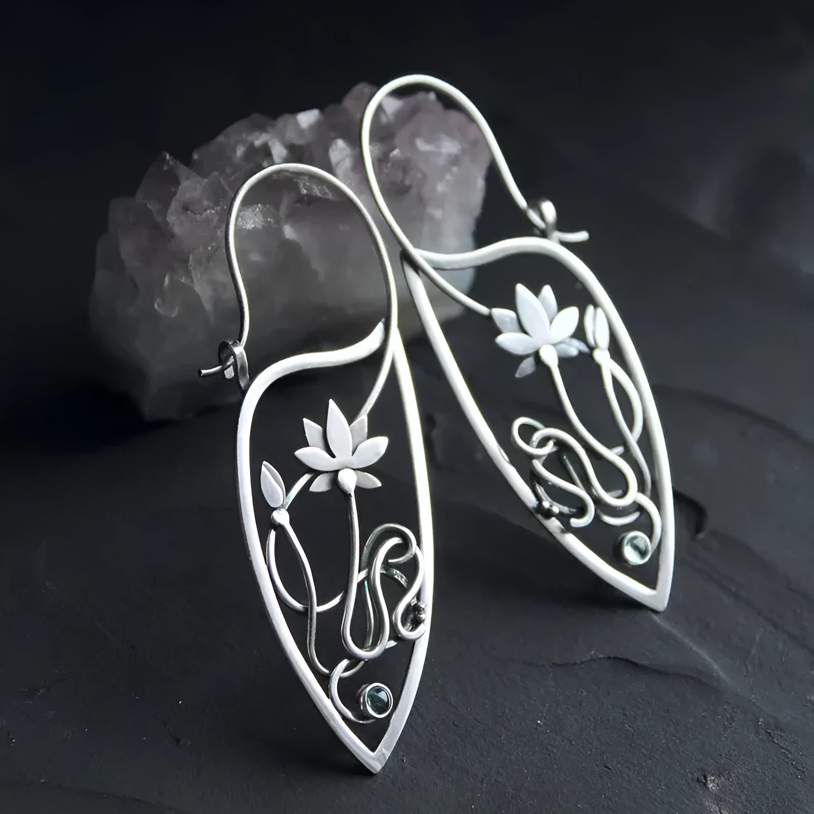 A pair of silver women's earrings with a lotus vine and geometric design featuring round rhinestones.