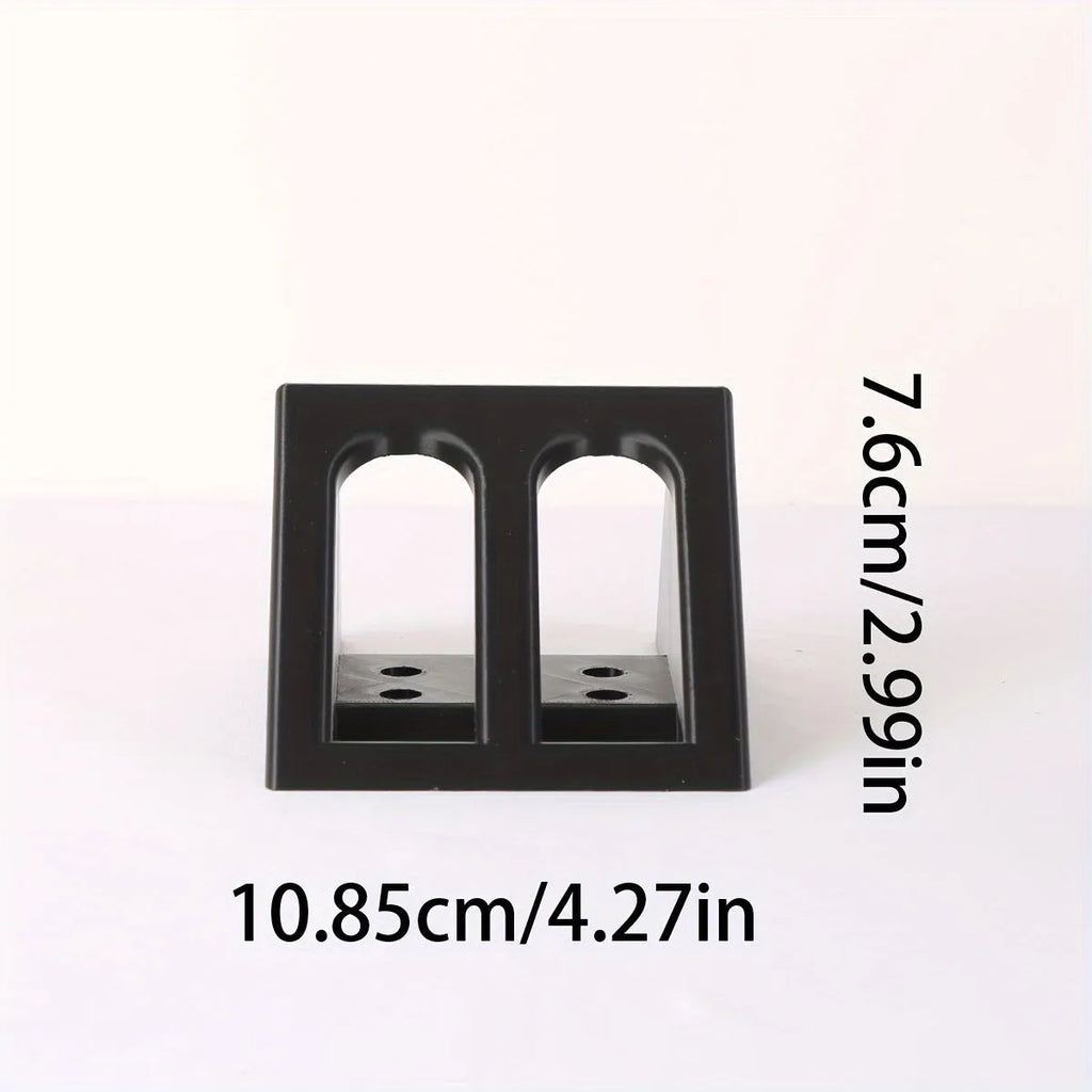 Black plastic pistol display stand for handguns and replicas on a flat surface.