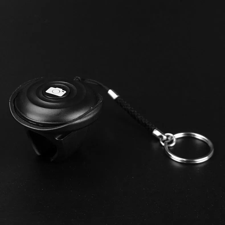 Black Bluetooth selfie remote control made of PC material weighing 27g