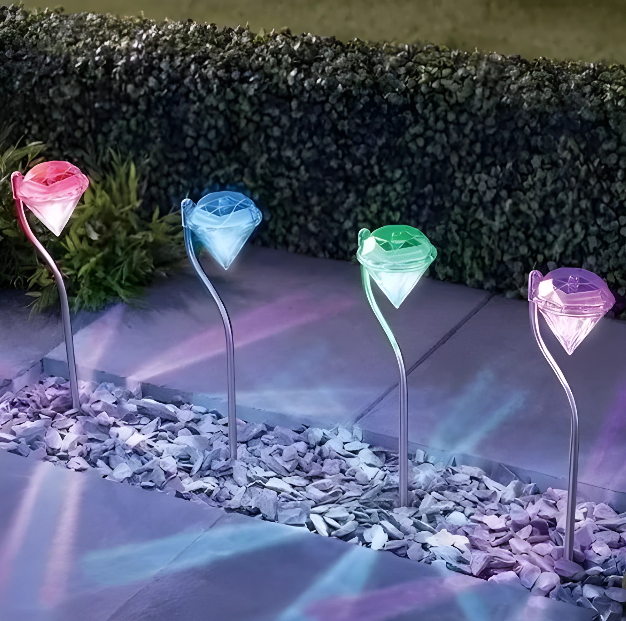 White solar-powered garden spotlight with adjustable head on a metal stake for outdoor use.