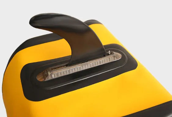 SUP paddle with large removable plastic fish fins attached via screw mechanism.