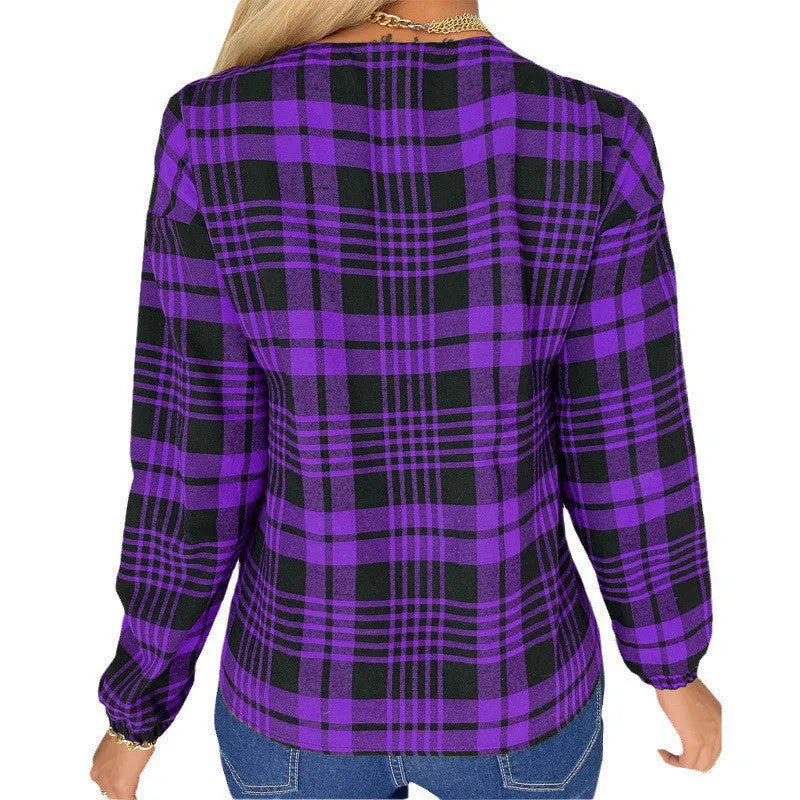 Woman wearing a loose-fitting purple plaid casual shirt with regular sleeves.
