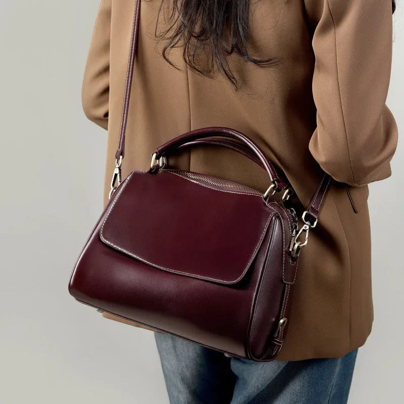 Women's genuine leather crossbody tote bag in apricot colour showing outer slit pocket and double shoulder straps
