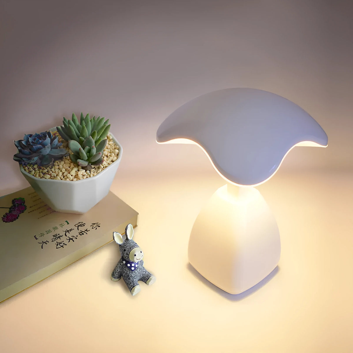 White plastic LED desk lamp with touch controls and built-in battery for bedside use