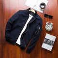 Men's slim-fit casual baseball jacket with front zipper and side pockets, shown in a solid colour.