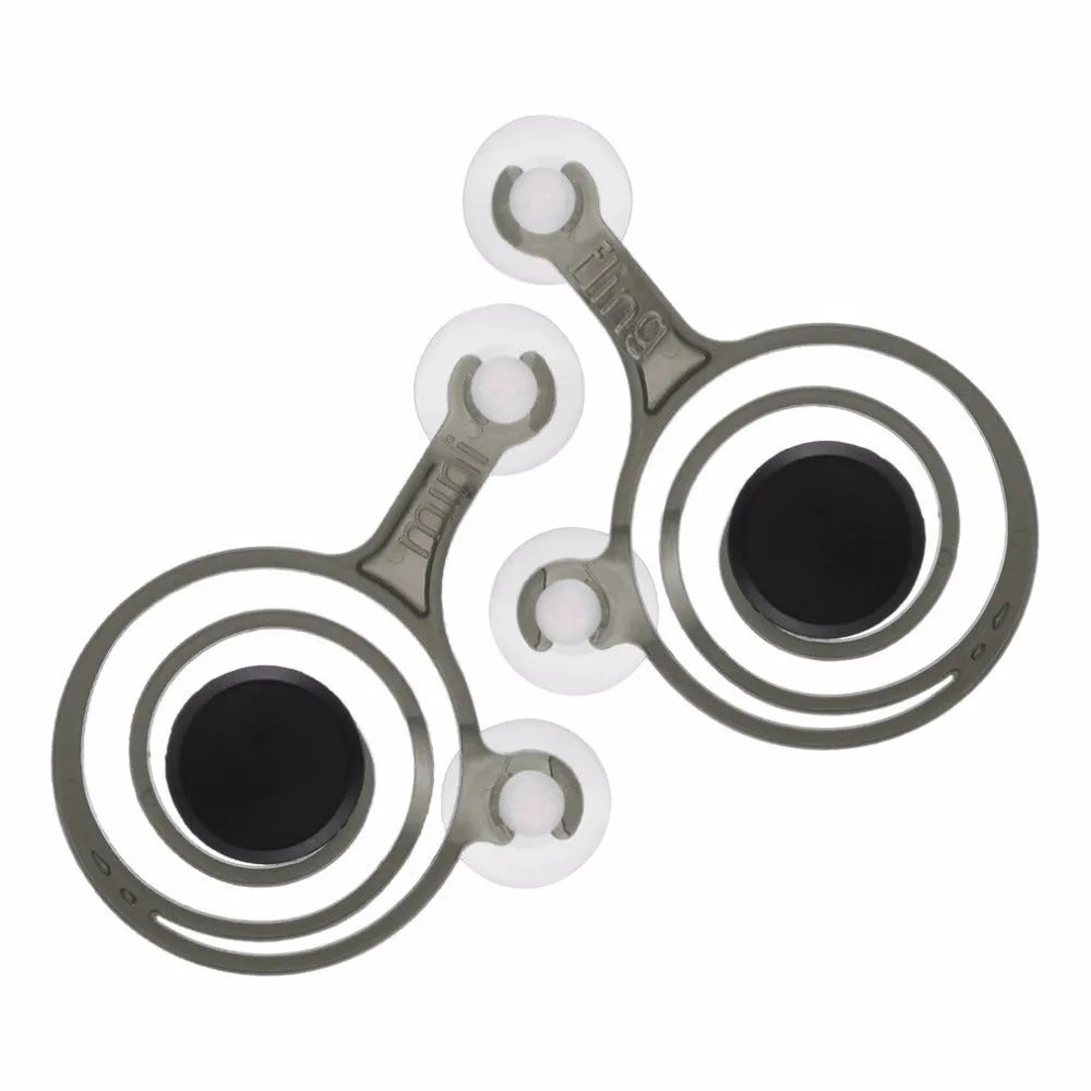 A pair of clear mini joysticks with black caps next to a drawstring bag, for mobile phone touch screen games.