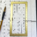 Solid brass square calligraphy paper weight with engraved design on a wooden desk.