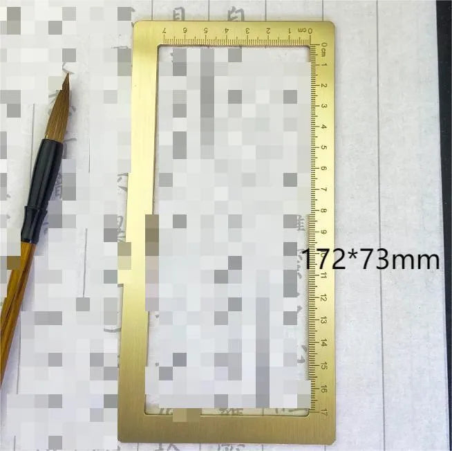 Solid brass square calligraphy paper weight with engraved design on a wooden desk.