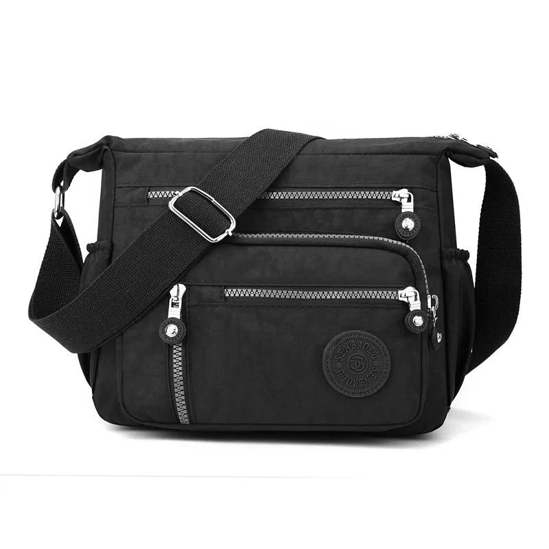 Grey soft nylon messenger bag with single adjustable shoulder strap showing square vertical shape